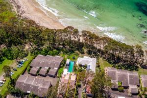 an aerial view of a house and the beach at Soulshine Beachside Penthouse in Surf Beach