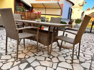 a table and chairs sitting on a patio at Apartments Zukanovic in Fažana