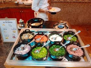 a stove with a bunch of different types of food at Holiday Inn Al Khobar by IHG in Al Khobar +84 photos