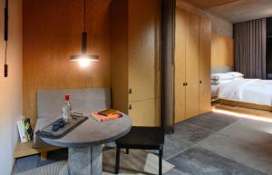 a room with a table and a bedroom with a bed at Volga in Mexico City