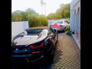 two cars parked in a driveway next to a house at Room in BB - Zagorskis Bed and breakfast in Cape Town