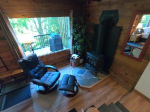 an overhead view of a living room with chairs and a stove at 4 Mile Creek Cabin (Creekside) in Nelson