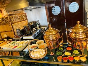 a buffet of food on a table in a kitchen at Golden Tulip Al Khobar in Al Khobar