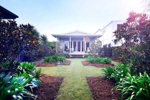 a house with a garden in front of it at Margaret House ~ Circa 1930 in Coffs Harbour