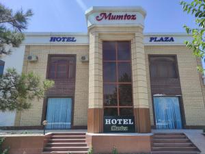 a hotel building with blue doors and stairs at Mumtoz Plaza in Bukhara