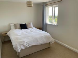Southwell的住宿－Sea views，卧室配有白色的床和窗户。