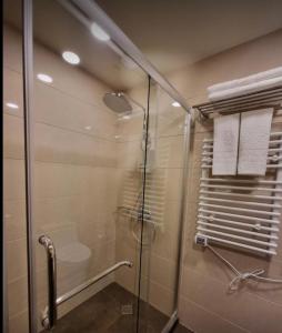 a shower with a glass door in a bathroom at Happy Days in Dreamland Oasis in Chakvi