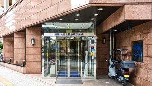 a scooter parked in front of a building at Toyoko Inn Osaka Taniyon Kosaten in Osaka +35 photos
