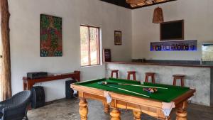 a room with a pool table and a bar at Naga Lodge in Luang Prabang