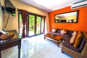 a living room with a couch and a mirror at Pondok DEWI Villa - LEGIAN - 6 Bedroom Villa - Great Location in Legian