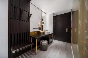 a bathroom with a black counter and a sink at CitiGO Huange Hotel, Shenzhen Shekou Cruise Center Seaview in Shenzhen