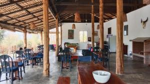 a dining room with tables and chairs in a room at Naga Lodge in Luang Prabang