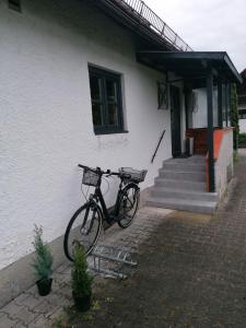 a bike parked in front of a house at Ferienwohnung Helli in Teisendorf