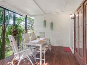 a dining room with a table and chairs on a porch at Great value 3BD house at a convenient location in Brisbane