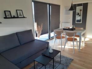 a living room with a couch and a table at Złotopolska Sielanka in Załuski