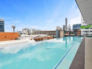 a large swimming pool on the roof of a building at Heart of the Valley Chic High Level 2BR Apartment in Brisbane
