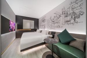 um quarto de hotel com uma cama e um sofá em CitiGO Hotel Shenzhen Shekou Cruise Center Seaview em Shenzhen