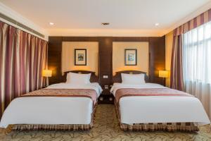 Voodi või voodid majutusasutuse Beijing Jinlong Hotspring Hotel toas