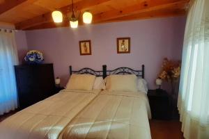 um quarto com uma cama grande e lençóis brancos em Casita Marian y Chema em Amusco