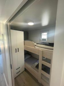 a small room with a bunk bed and a closet at Floating sea house - PULA 1 in Pula
