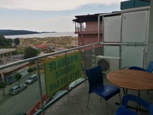a balcony with a table and chairs and a view of a street at Studio in Primorsko del Sol in Primorsko