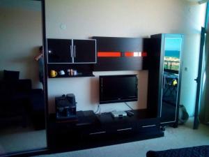 a entertainment center with a flat screen tv in a living room at Studio in Primorsko del Sol in Primorsko +8 photos