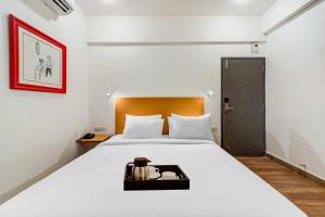 Posteľ alebo postele v izbe v ubytovaní Townhouse De Alphabet Tirupati