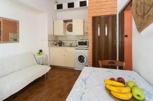 a plate of fruit on a table in a living room at Seascape Krithoni in Agia Marina