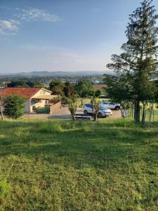 a view of a yard with cars parked in a field at Gites panoramique in Sainte-Livrade-sur-Lot