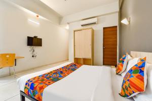 a hotel room with a bed and a desk at Via Kaviya - Bopal in Ahmedabad