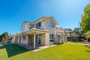 a large house with a lawn in front of it at Spacious newly redecorated 5BD Family Home in Brisbane