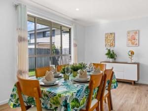 a dining room with a table and chairs at Spacious Newly Furnished 4BD Family Retreat in Doolandella