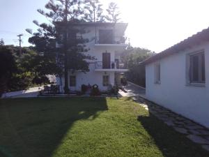 a large white house with a yard in front of it at Villa Ourania in Troulos