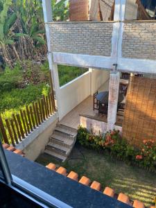 a porch with stairs and a bench on a house at Estalagem Sol de Boipeba in Ilha de Boipeba