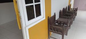 - un groupe de chaises dans une pièce avec porte dans l'établissement SPOT ON 92658 Wisma Parakita Syariah, à Makassar