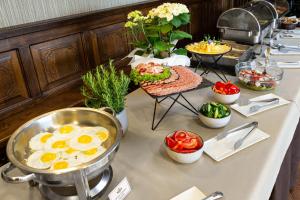 a table with eggs and other food on it at Kamelot in Ternopil