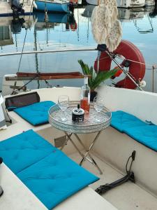 a table on a boat with glasses on it at Bateau port Cap d'Agde in Cap d'Agde