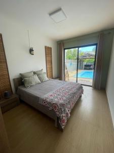 a bedroom with a bed and a sliding glass door at Villa Coco in Trou aux Biches