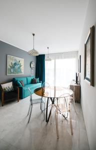 a living room with a glass table and a couch at Taormina Argo Apartment by Taormina Holidays in Taormina