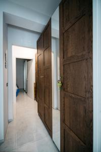 a hallway with a large wooden door in a house at Taormina Argo Apartment by Taormina Holidays in Taormina +9 photos