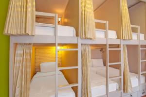 a bunk bed room with four bunk beds in it at Capital O 92559 Sweet Peach House in Senggigi