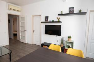 a living room with a table and yellow chairs at Apartment Carrer de Joan in Barcelona