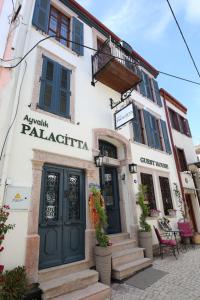 a building with a door and a balcony at Ayvalık Palacitta Guesthouse in Ayvalık