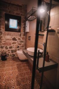 a bathroom with a sink and a toilet in it at Ayvalık Palacitta Guesthouse in Ayvalık