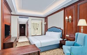 una camera da letto con un letto, una scrivania e una sedia di Guangming CIMC Executive Hotel Shenzhen a Shenzhen