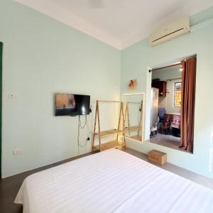 a bedroom with a bed and a large mirror at Camelia Homestay in Hanoi