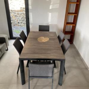 a wooden table and chairs with a leaf on top at Villa 4 étoiles SAINT LEU - Dodoterla in Saint-Leu +6 photos