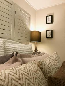 a bedroom with a bed and a lamp and a window at Jacaranda House Garden Suite in Brisbane
