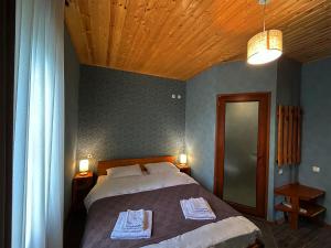 מיטה או מיטות בחדר ב-Hotel VIM in Sighnaghi