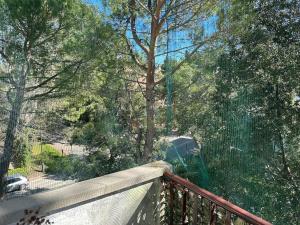 a balcony with a fence and trees and a street at Immobile Vintage a Grado Pineta in Grado-Pineta